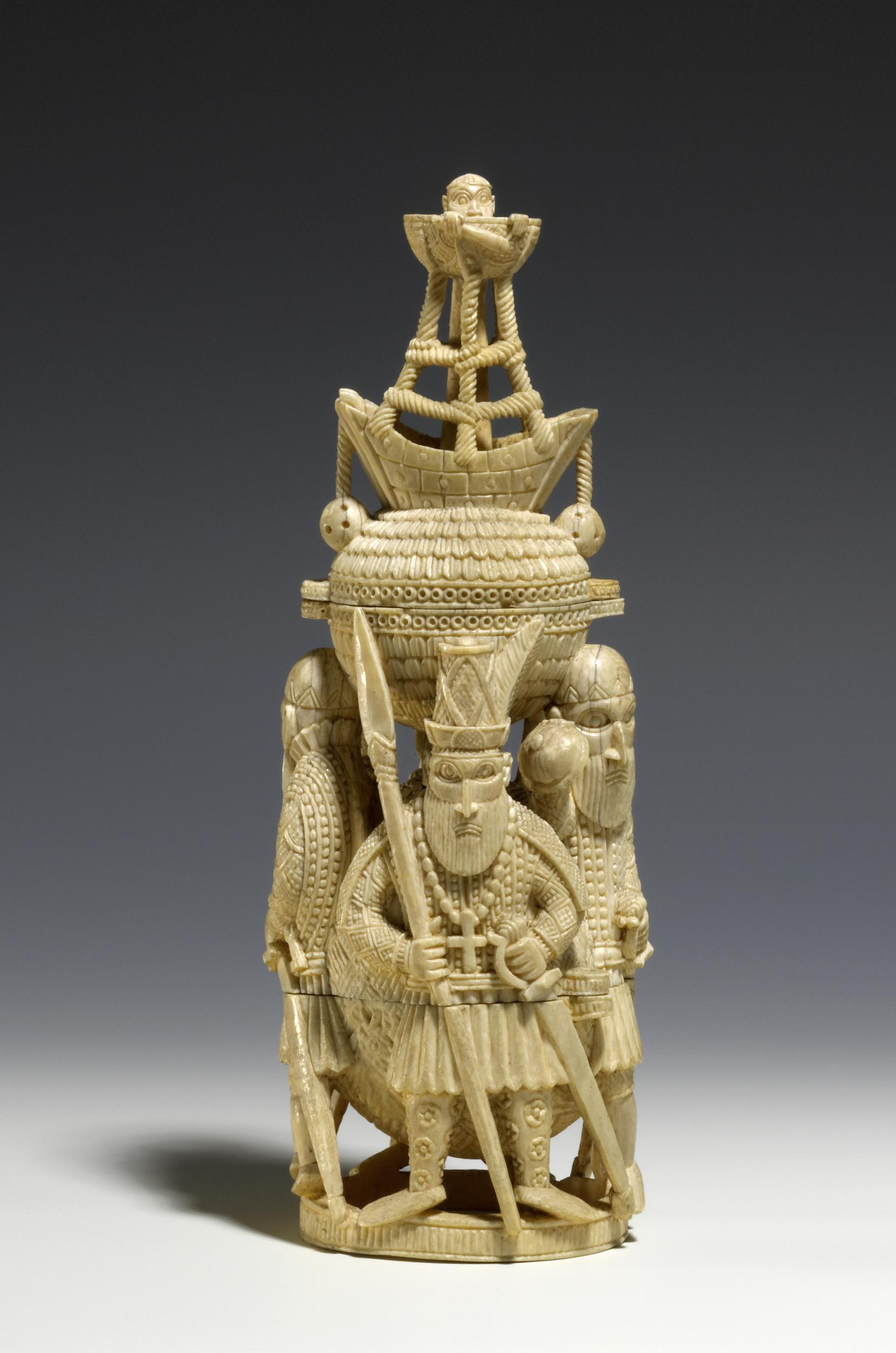 Preview of: Salt Cellar Petite sculpture en ivoire finement sculptée représentant des personnages portant un récipient surmonté d'un navire, dans un style médiéval nordique.