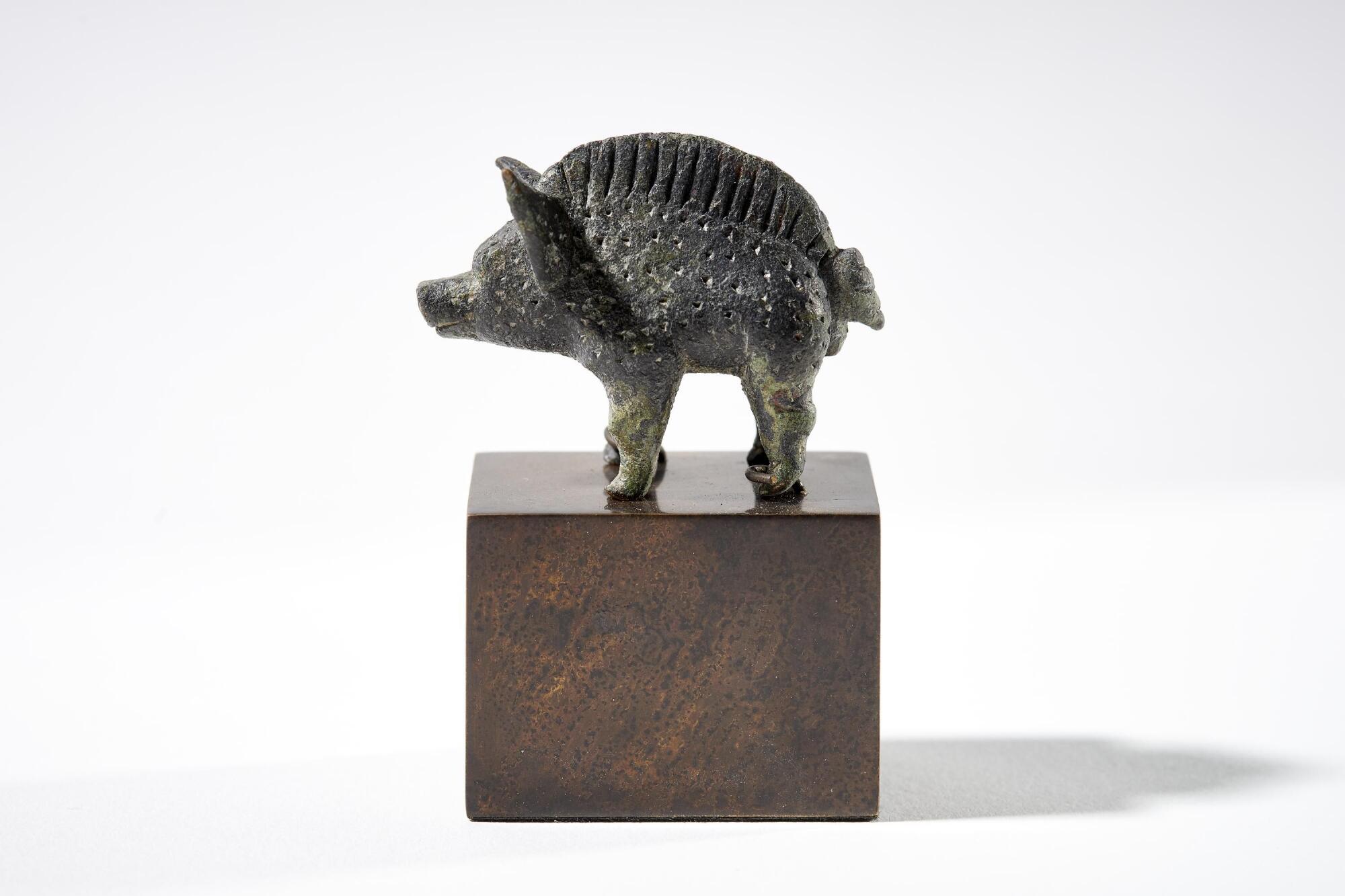 Preview of: Small wild boar from the Titelberg Petite figurine en bronze représentant un sanglier stylisé, caractérisé par une crête dorsale et un décor ponctué.
